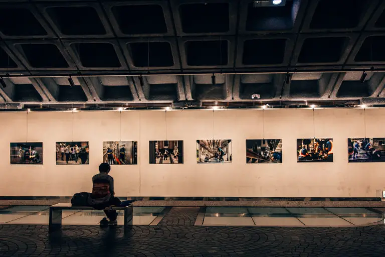 lady sitting in front of photography at metro gallery