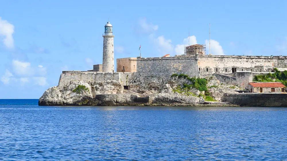 lighthouse and fort in front of the sea
