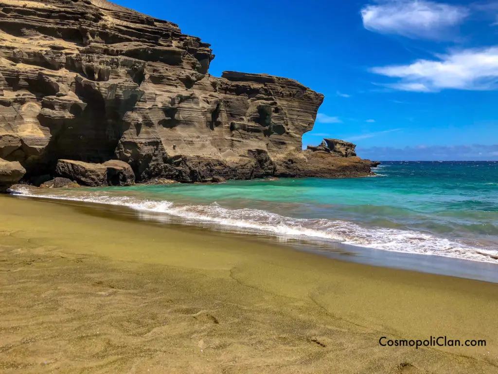green sand beach with turquoise waters